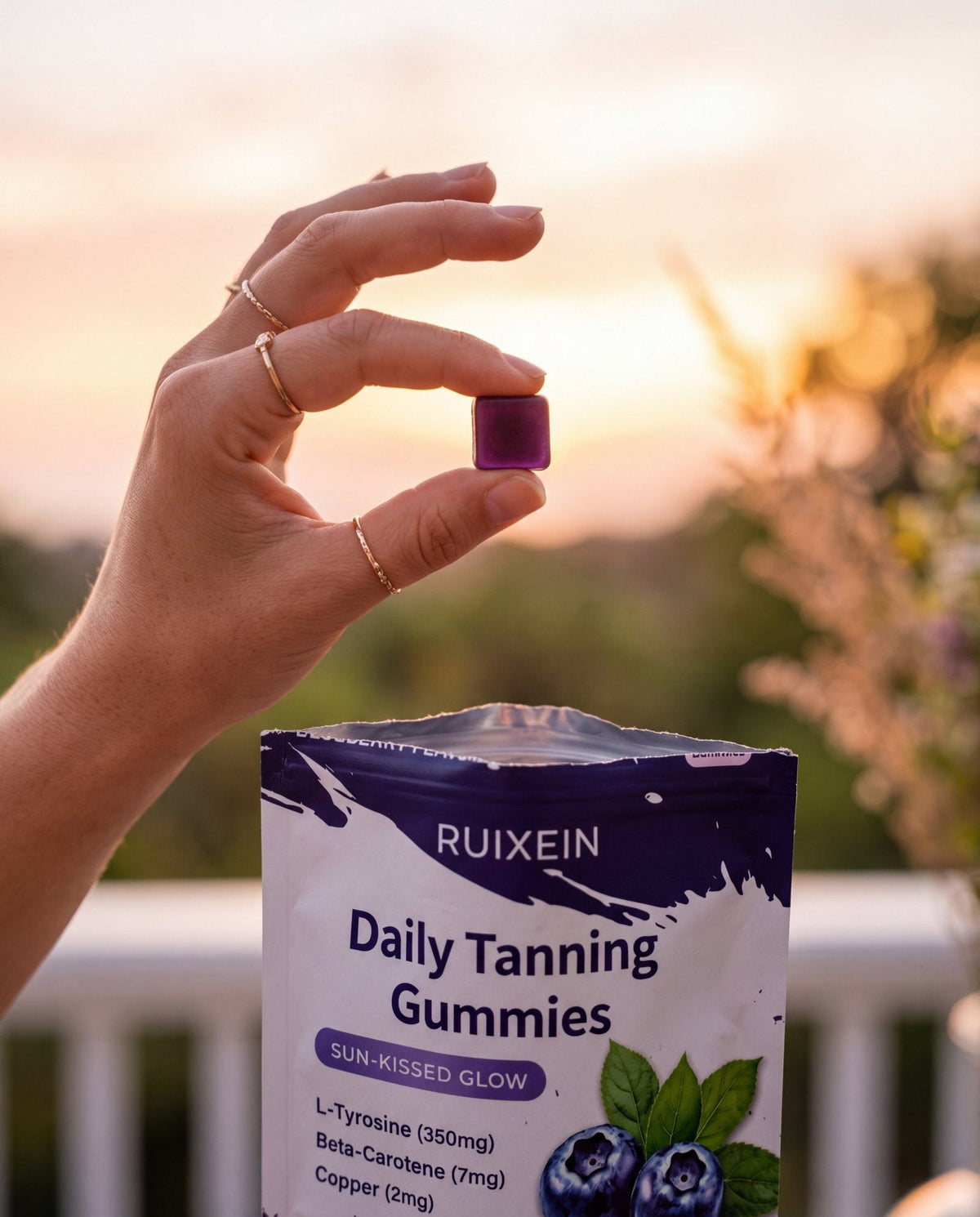 Hand holding a Tannies Daily Tanning Gummies pouch